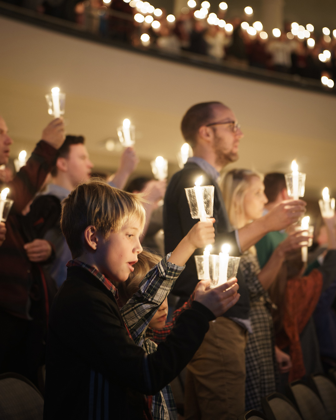 A family holds their candle at the annual Christmas Eve service at Perimeter Church